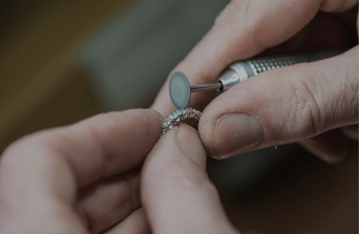 Jeweler polishing diamond ring