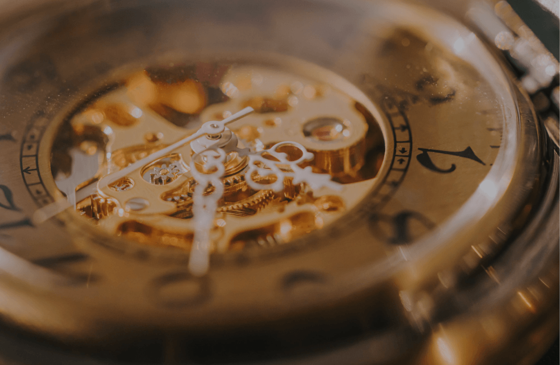 Intricate gears inside a golden watch
