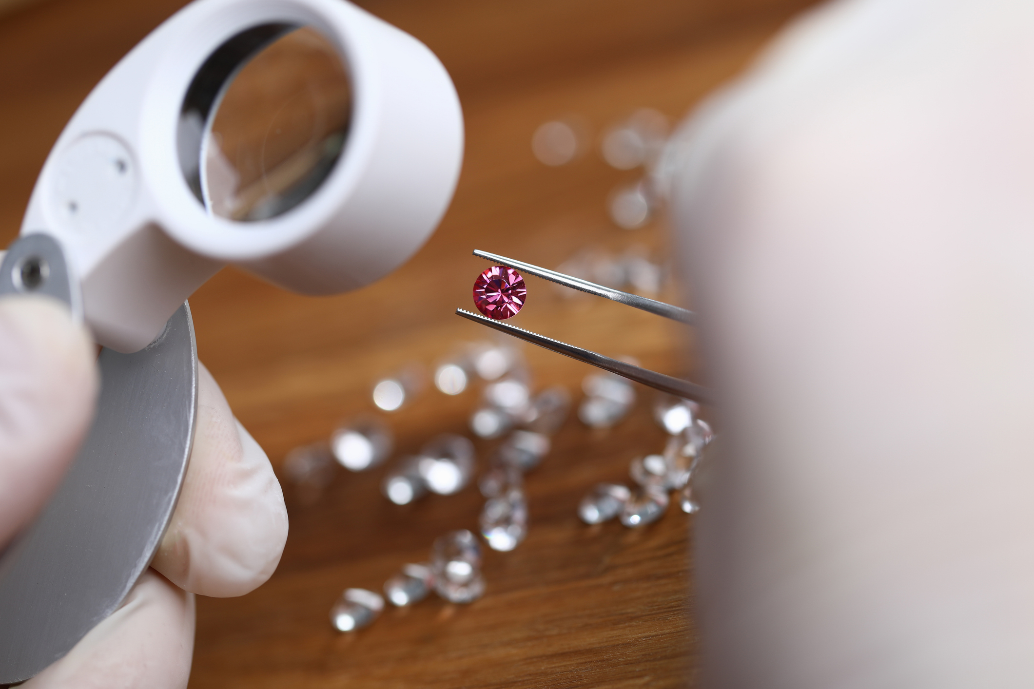 Analyzing gemstones with magnifying glass