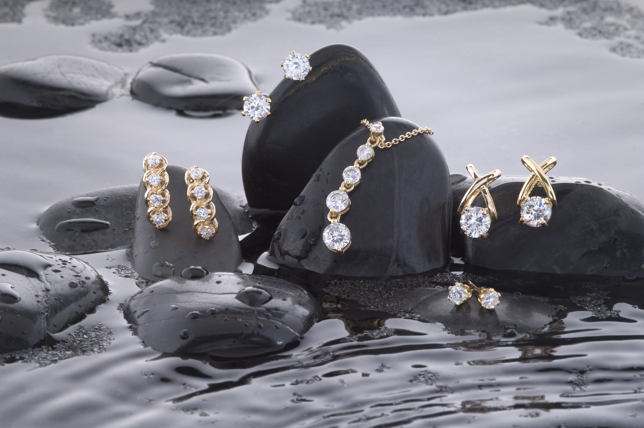 Diamond jewelry on wet black spa stones