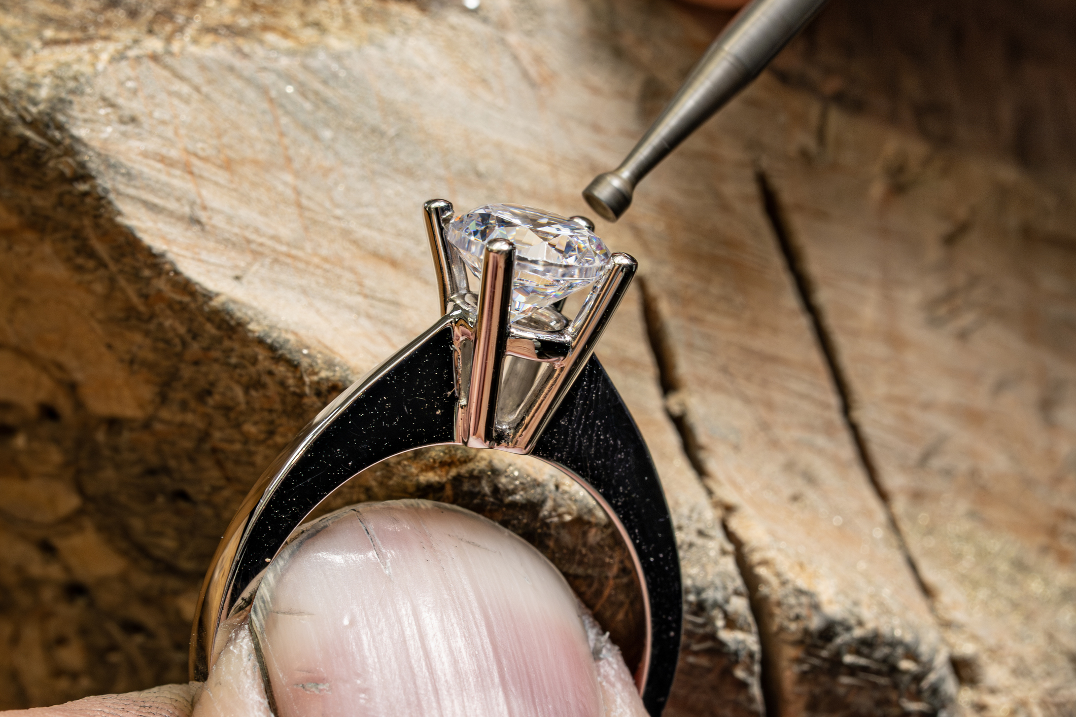 Jeweler setting diamond into ring