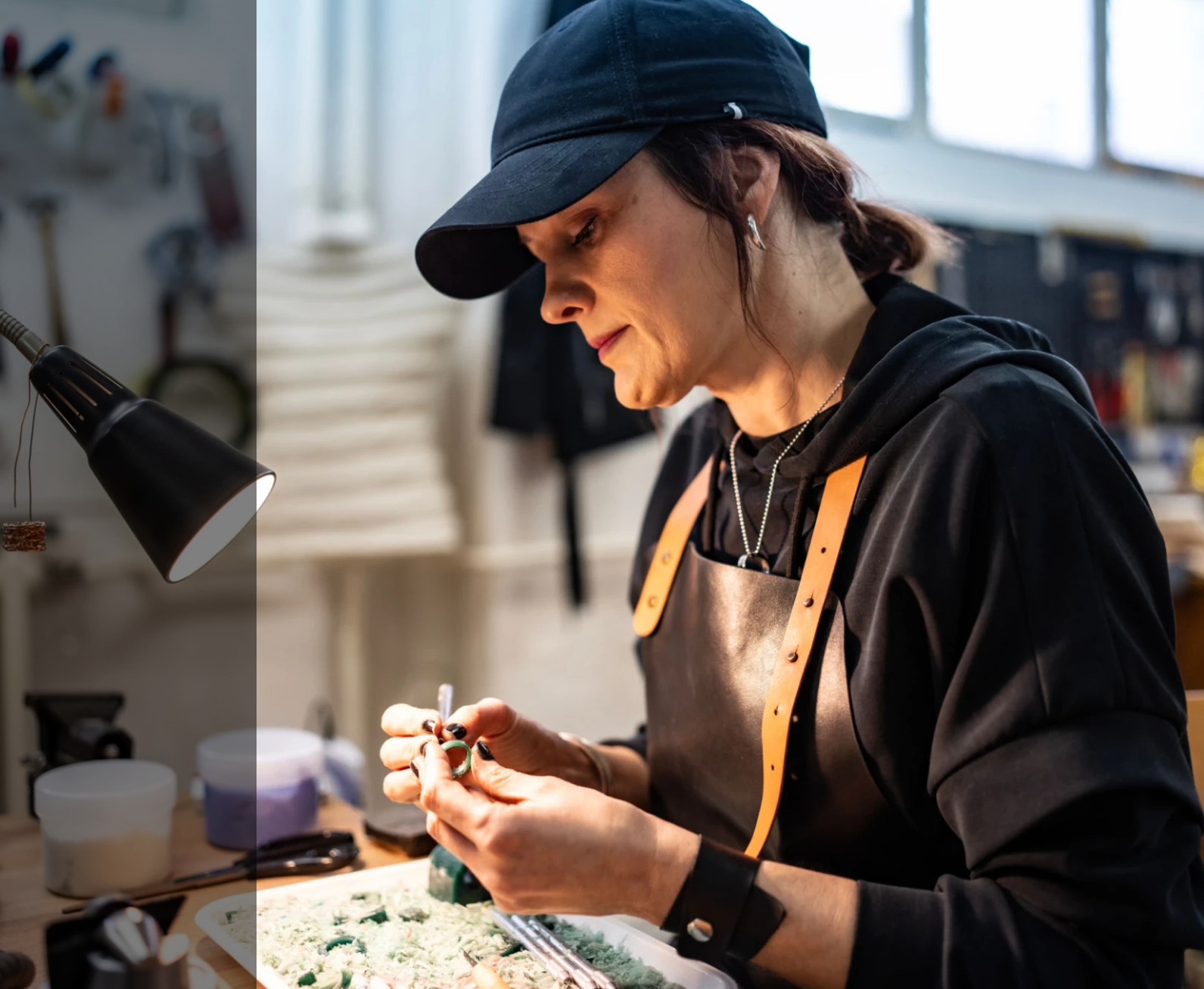 Person crafting jewelry at workshop bench