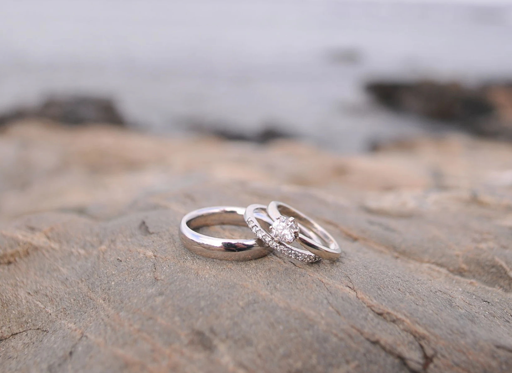 Diamond engagement and wedding rings on rock